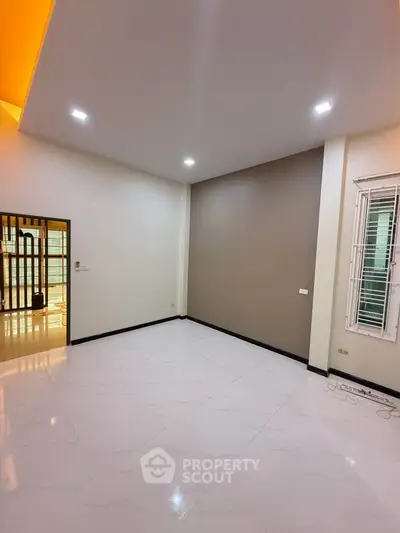 Spacious modern living room with sleek design and bright lighting, perfect for contemporary living.