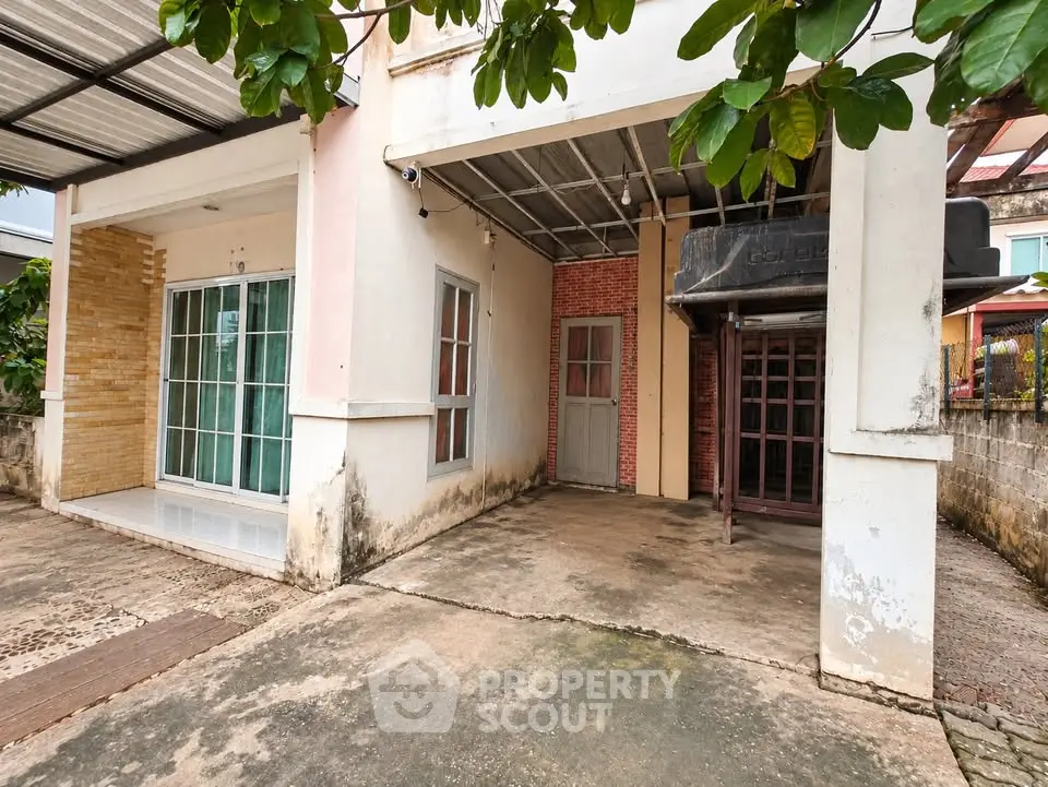 Charming residential property with covered parking and lush greenery, ideal for family living.