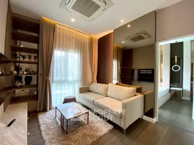 Modern living room with cozy sofa, elegant decor, and large window for natural light.