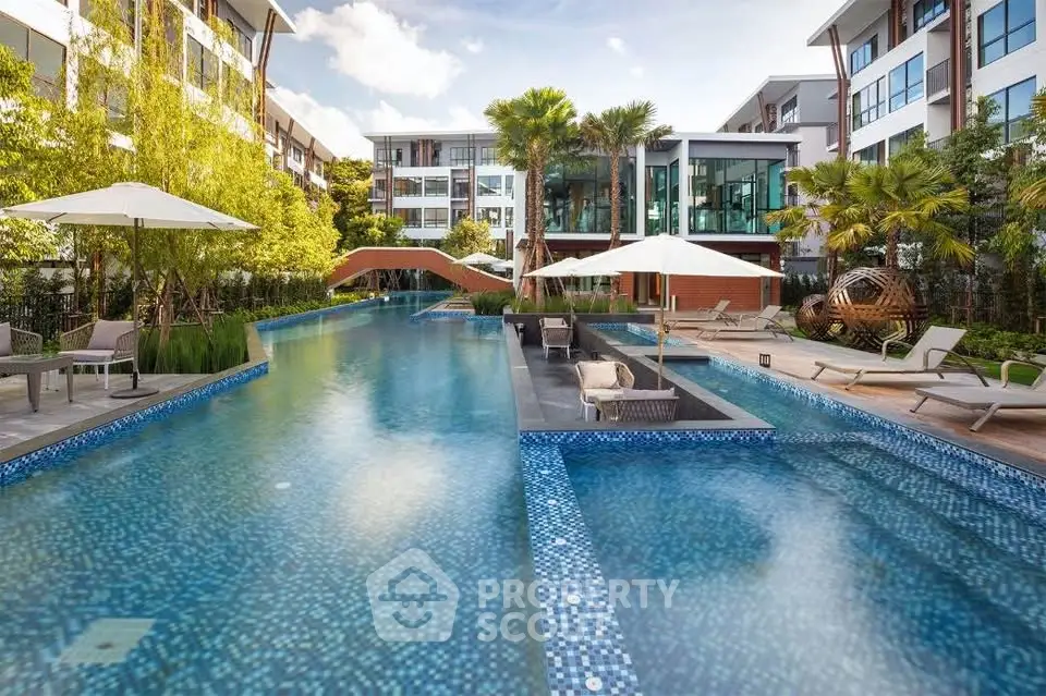 Luxurious residential complex with stunning outdoor pool and modern architecture.