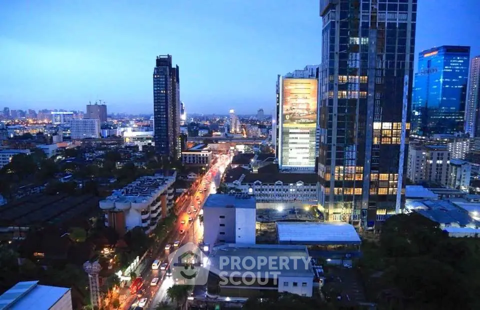 Stunning cityscape view from a high-rise building at dusk, showcasing vibrant urban life.