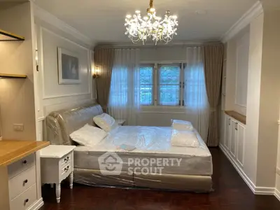 Luxurious bedroom with elegant chandelier and stylish decor