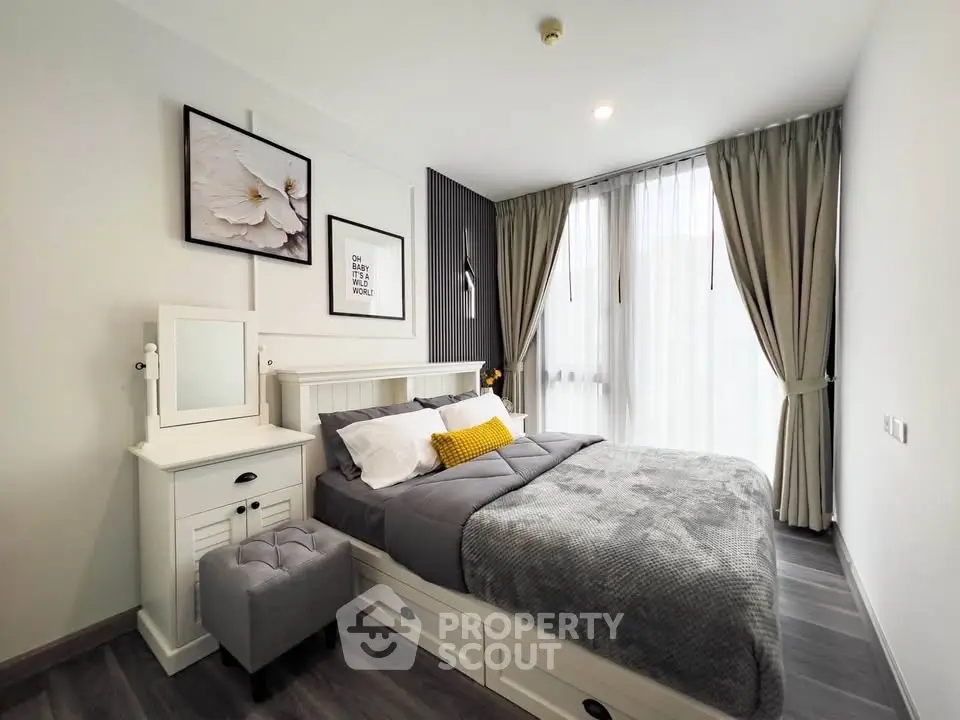 Cozy modern bedroom with stylish decor and ample natural light