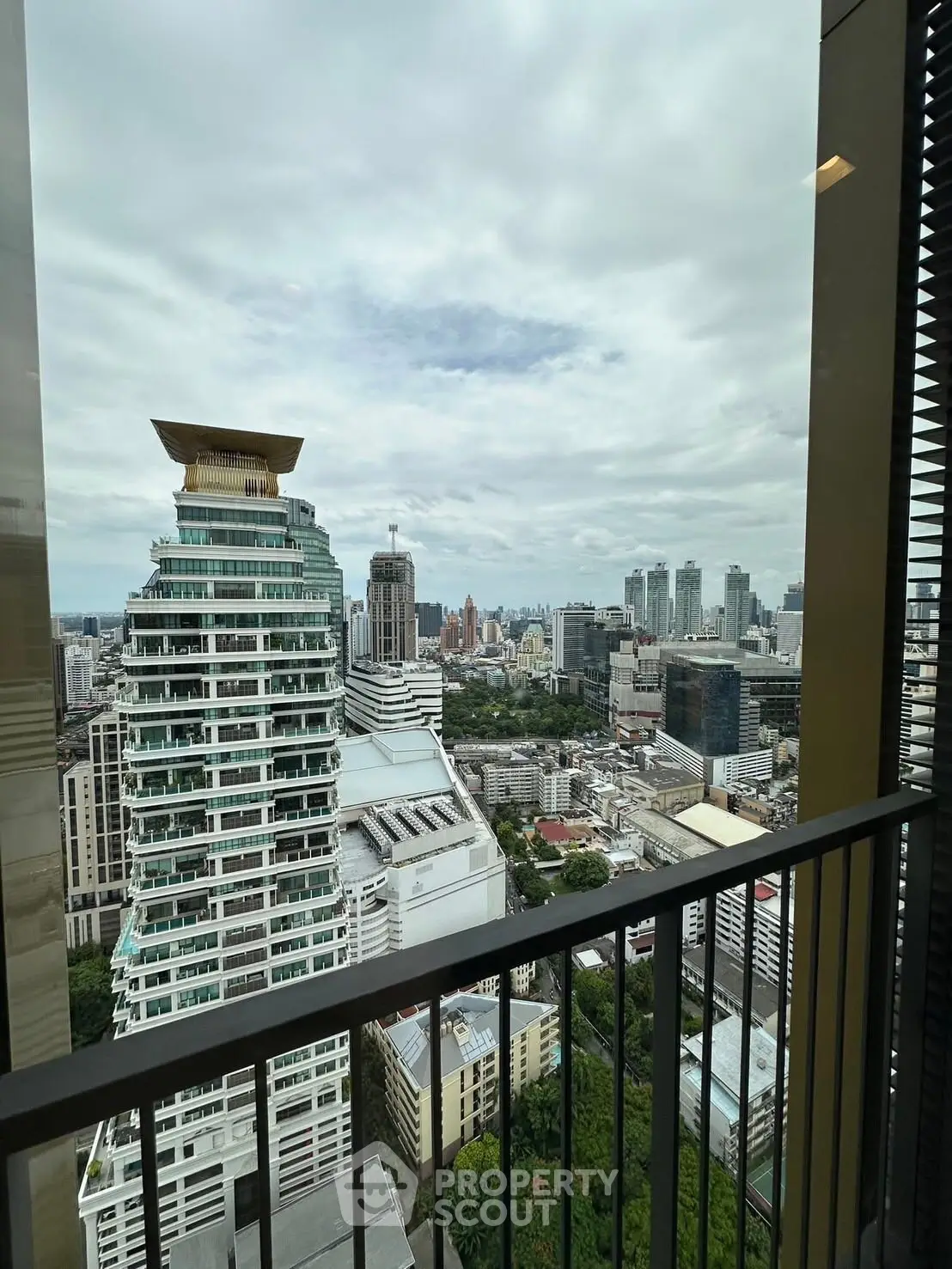 Stunning cityscape view from a high-rise balcony with modern architecture.