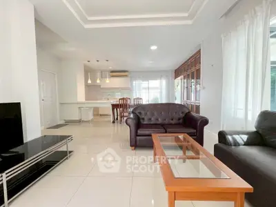 Spacious open-plan living room with modern furniture and natural light