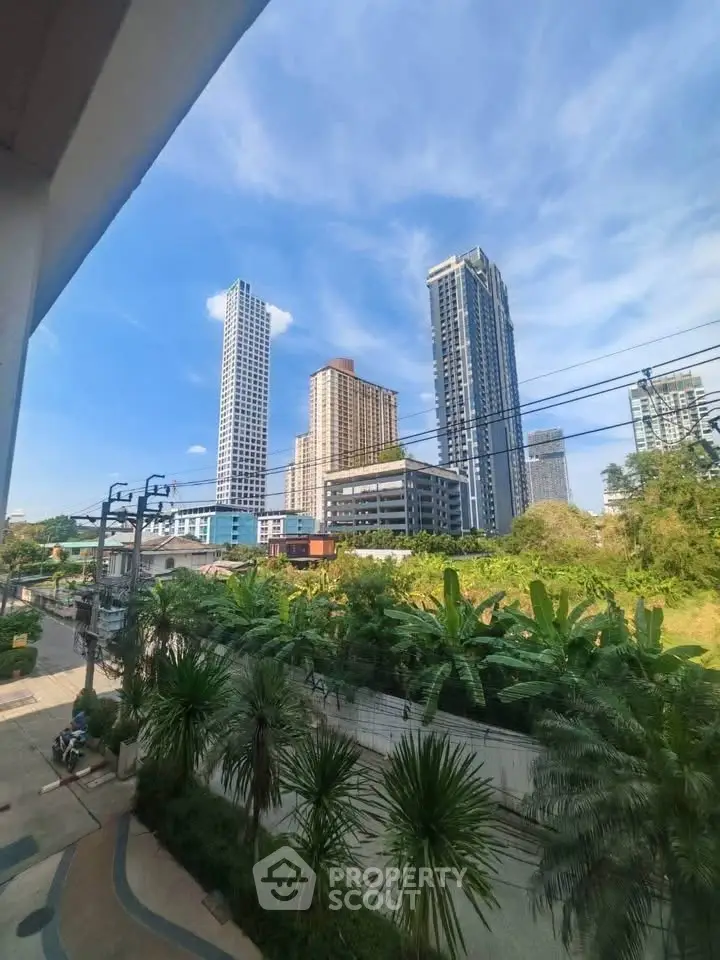 Stunning cityscape view with modern high-rise buildings and lush greenery, perfect for urban living enthusiasts.