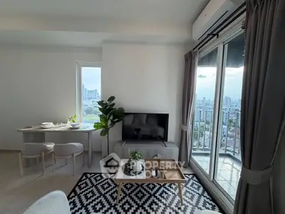 Modern living room with city view, featuring stylish decor and large windows for natural light.