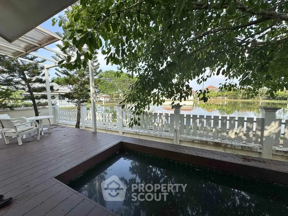Charming outdoor deck with private pool and serene lake view, perfect for relaxation and entertaining.