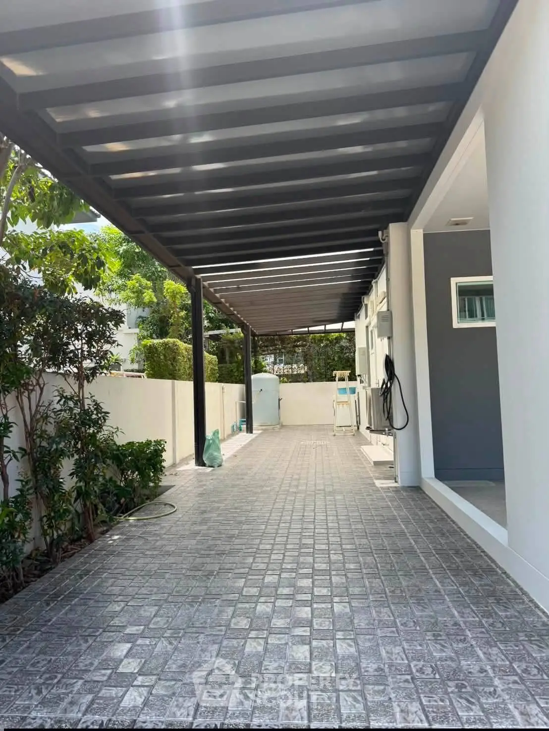 Spacious covered parking area with modern design and lush greenery