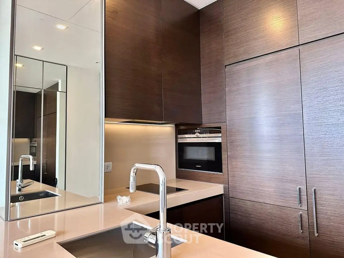 Modern kitchen with sleek cabinetry and built-in oven