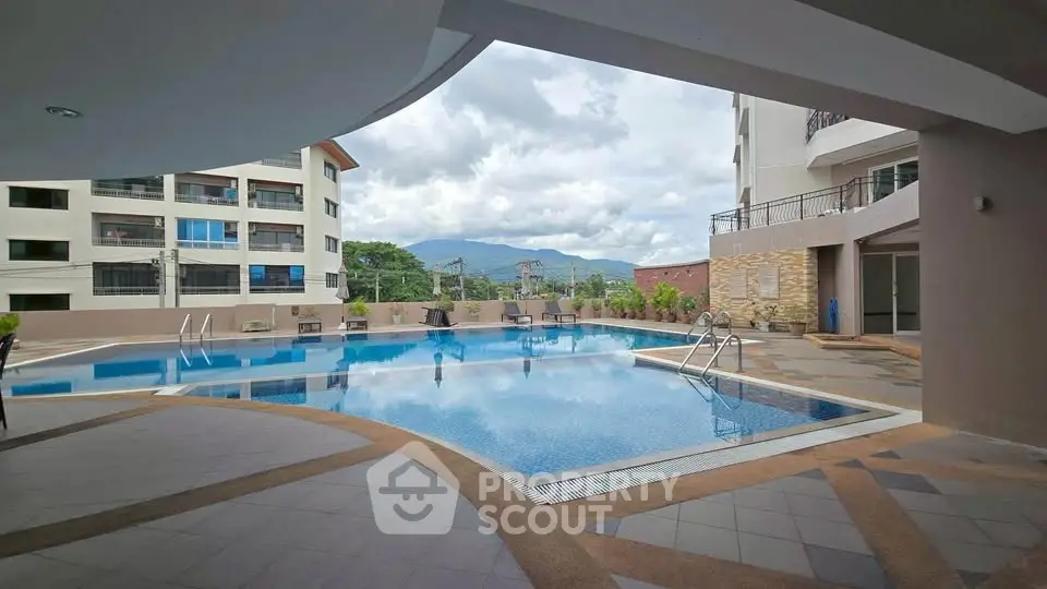 Luxurious apartment complex with stunning pool and mountain views, perfect for relaxation and leisure.