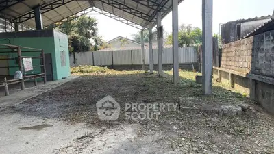 Spacious outdoor area with covered structure, ideal for versatile use in real estate development.