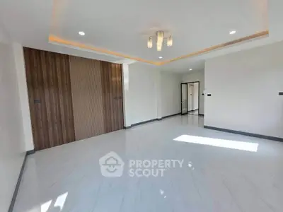 Spacious modern living room with elegant lighting and large windows
