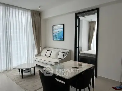 Modern living room with elegant decor and natural light in a stylish apartment.