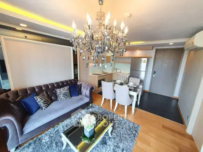 Luxurious living room with elegant chandelier and modern decor in upscale apartment