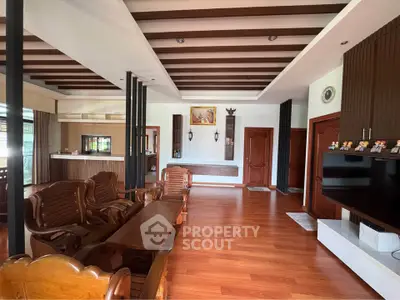 Spacious living room with wooden flooring and elegant decor