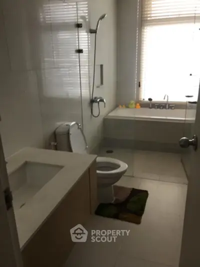 Modern bathroom with bathtub and shower in sleek design