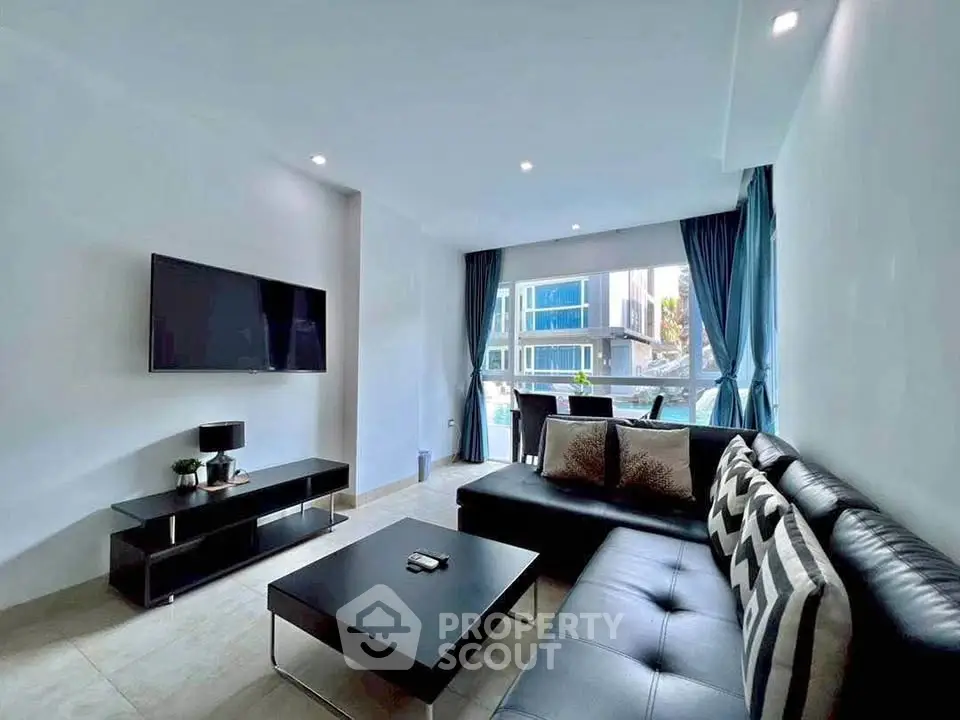 Modern living room with sleek furniture and large window offering city view