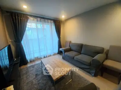Cozy living room with modern furniture and large window