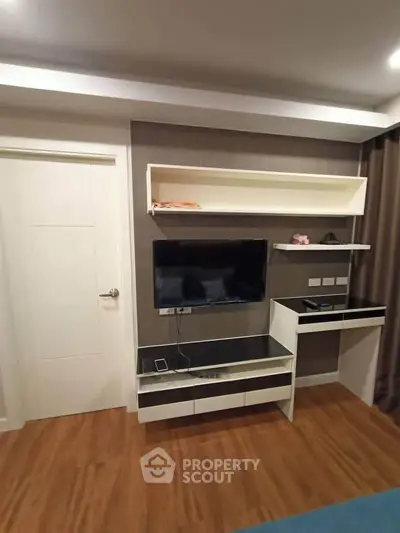 Modern living room with sleek TV unit and stylish wooden flooring