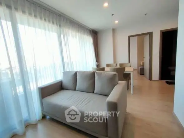 Spacious living room with modern furniture and large windows offering natural light.