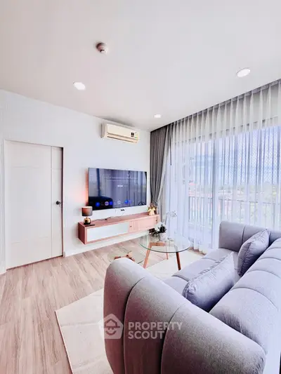 Modern living room with sleek design and large window view