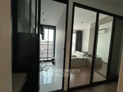 Modern apartment interior with glass partitions and balcony view