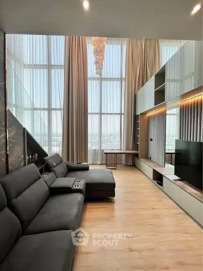 Luxurious high-ceiling living room with modern decor and panoramic windows