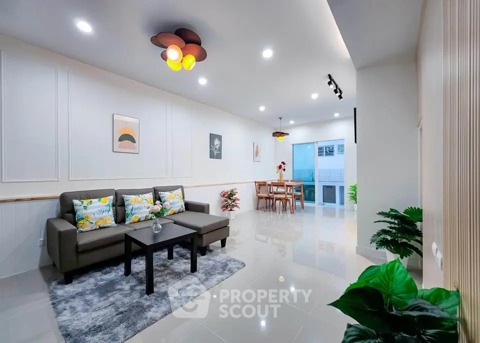 Spacious modern living room with stylish decor and ample natural light