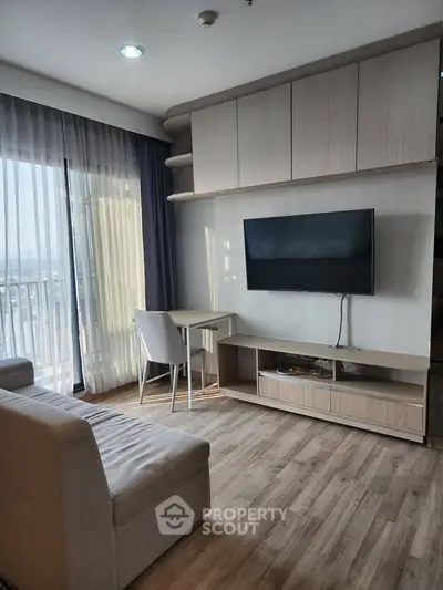 Modern living room with sleek furniture and large window offering natural light and city view.