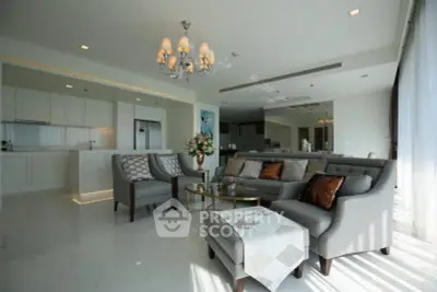 Luxurious open-layout living room with elegant furniture and modern kitchen in a high-end apartment.