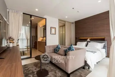 Modern studio apartment with cozy living area and elegant bedroom design.