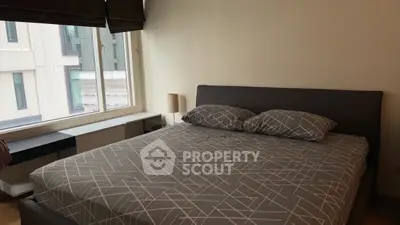 Cozy bedroom with modern decor and large window view