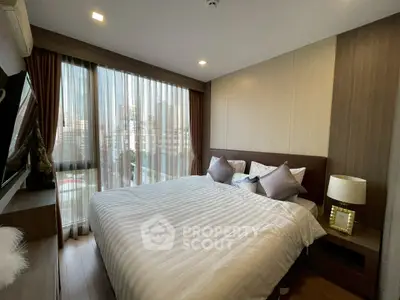 Spacious bedroom with large windows and city view in modern apartment