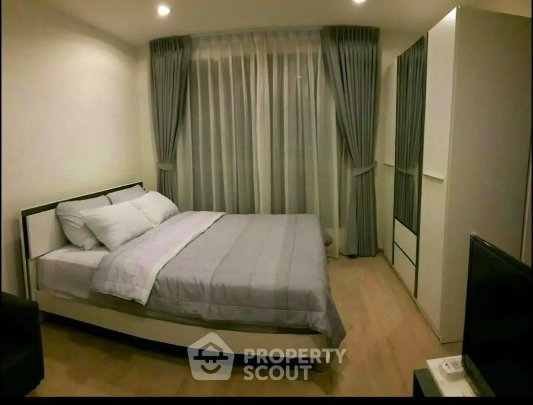 Cozy bedroom with modern decor and ample natural light