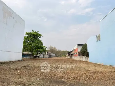 Vacant land plot between buildings, ideal for development opportunities.