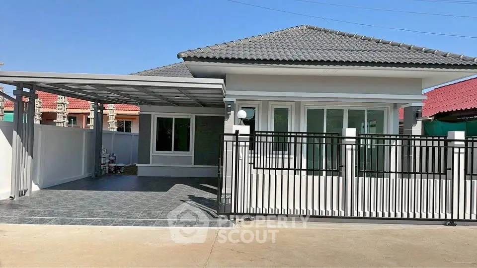 Charming single-story house with modern design and spacious driveway in a serene neighborhood.
