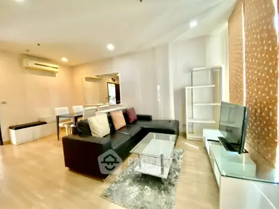 Modern living room with sleek furniture and stylish decor in a cozy apartment setting.