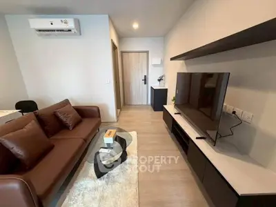 Modern living room with sleek furniture and wall-mounted TV, perfect for urban living.