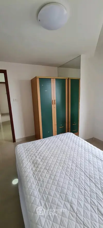 Spacious bedroom with modern wardrobe and cozy bed in a bright apartment.