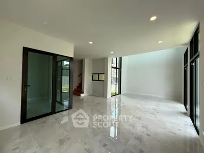 Spacious modern living room with marble floors and large windows