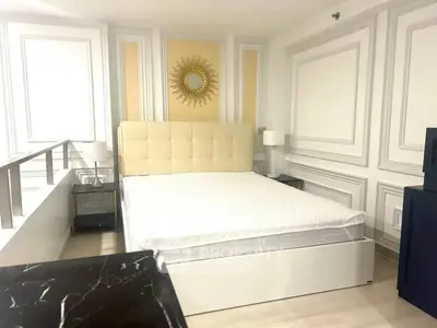 Luxurious bedroom with elegant decor and plush bed in modern apartment