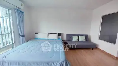 Spacious bedroom with balcony view and modern furnishings in a high-rise apartment.