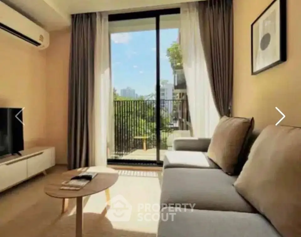 Modern living room with large sofa and balcony view in urban apartment