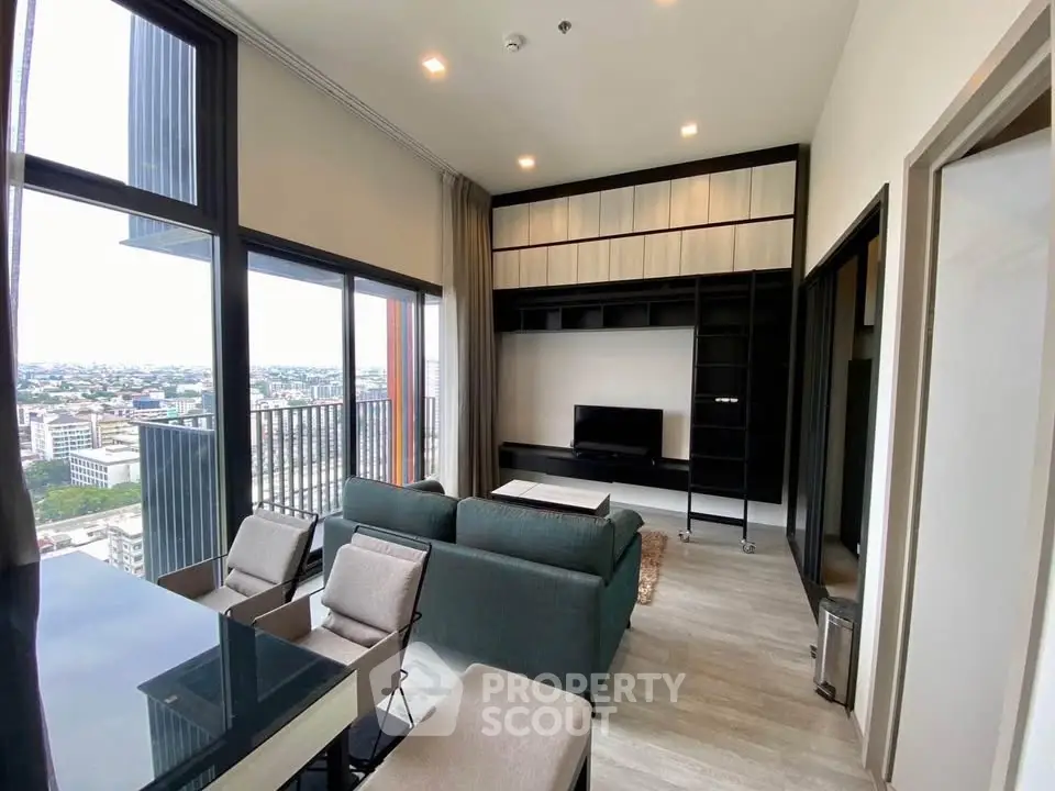Modern living room with floor-to-ceiling windows and city view, featuring sleek furniture and built-in shelving.