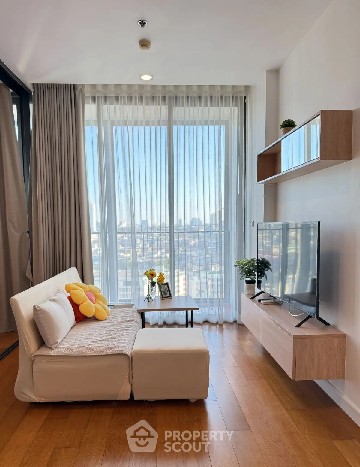 Modern living room with floor-to-ceiling windows and city view