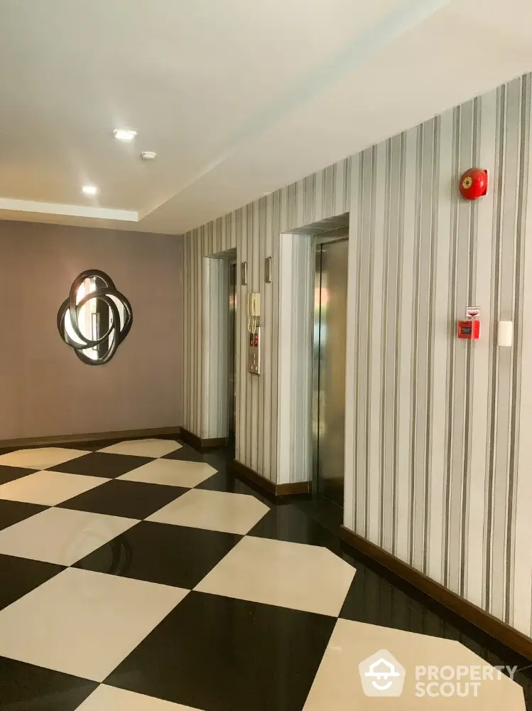 Modern building elevator lobby with stylish decor and checkered flooring