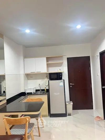 Modern kitchen with sleek design and compact layout in a stylish apartment