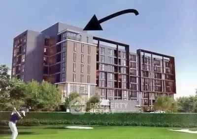 Modern apartment building with lush green surroundings and golf course view.