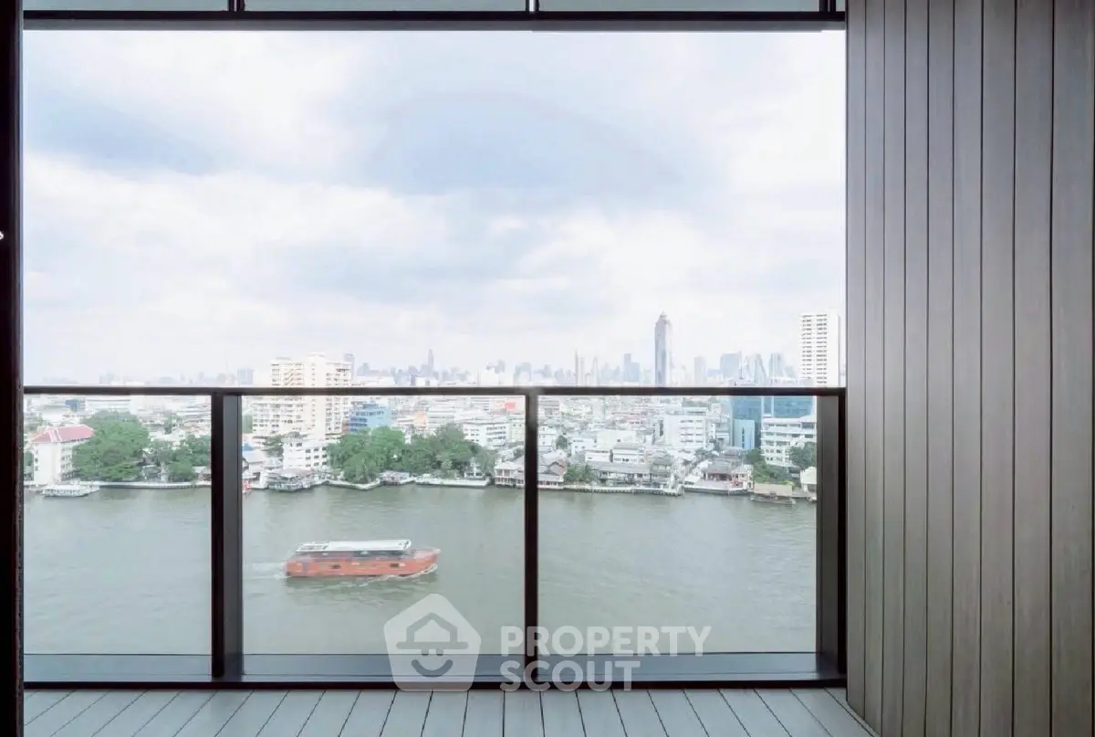 Stunning river view from a modern balcony in a high-rise apartment, showcasing city skyline.
